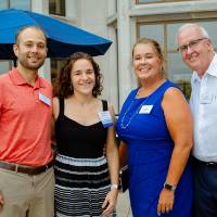 A group of four guests posing for a photo.